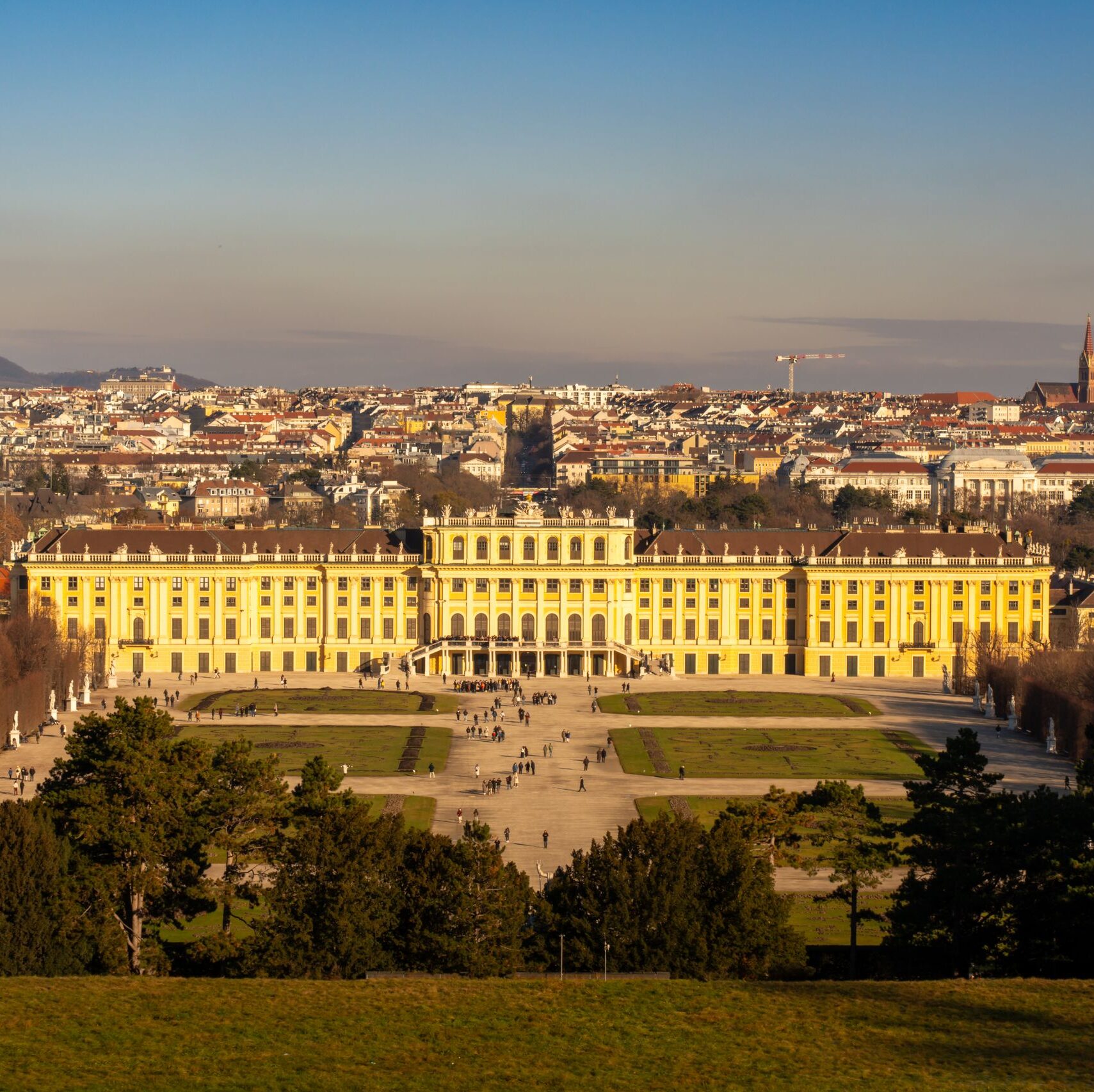 Panoramic view of Schonbrunn Palace in Vienna, Austria under a clear daytime sky.